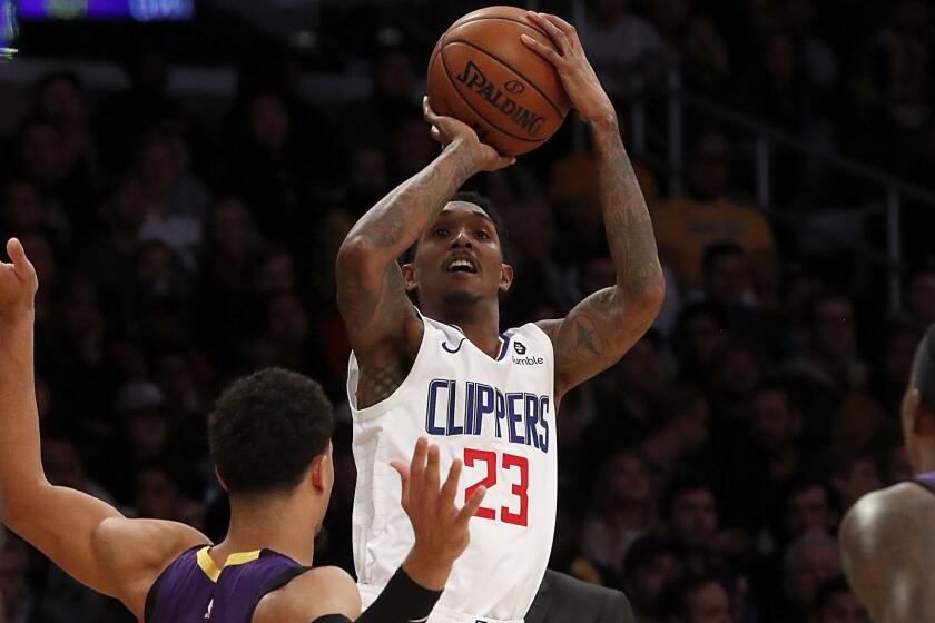 LOS ANGELES, CALIF. - DEC. 28, 2018. Clippers guard Lou Williams shoots over Lakers guard Josh Hart, left, and Kentavious Caldwell-Pope in the fourth quarter Friday night, Dec. 28, 2018, at Staples Center. (Luis Sinco/Los Angeles Times)
