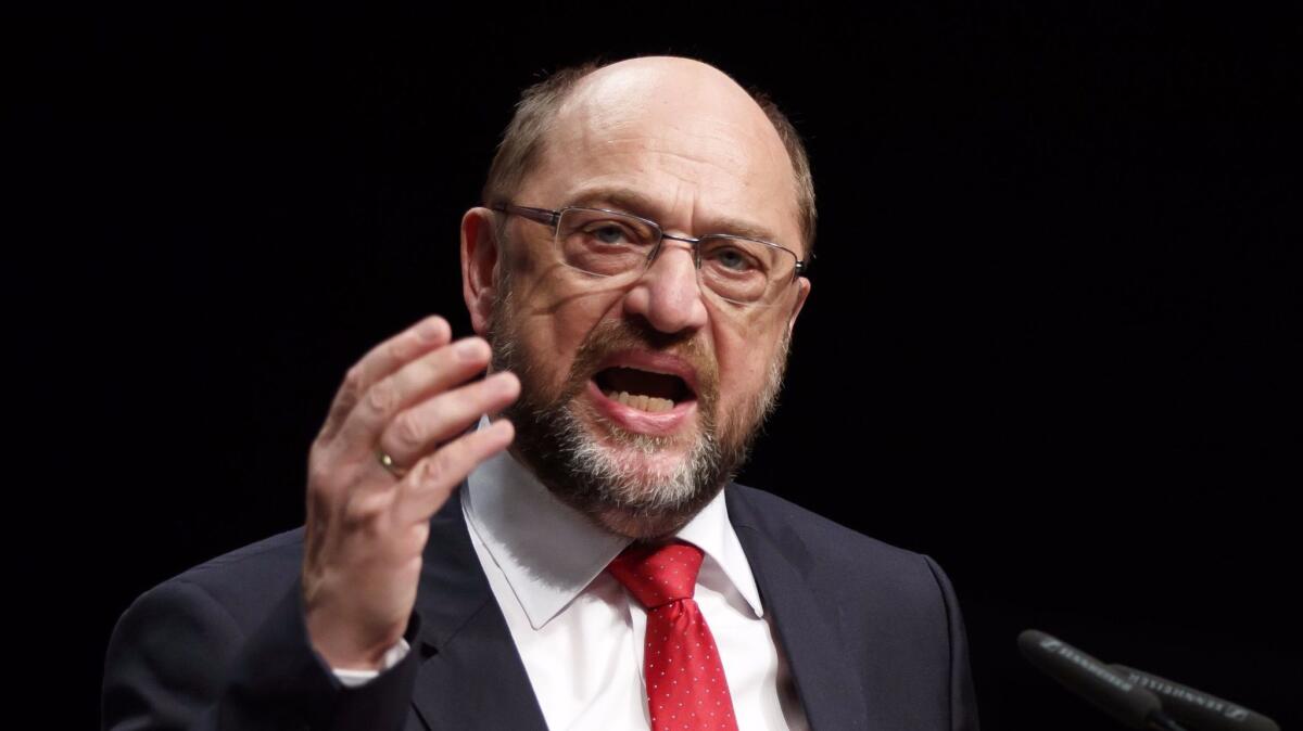 Martin Schulz, speaking Friday in Berlin, says his Social Democratic Party is open to forming a coalition government with Chancellor Angela Merkel's conservatives.