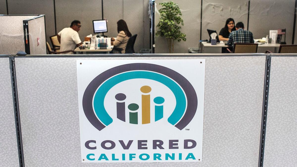Insurance agents help sign people up for insurance through a Covered California exchange in Huntington Beach last year. Open enrollment for 2018 coverage begins Nov. 1 and runs through Jan. 31.