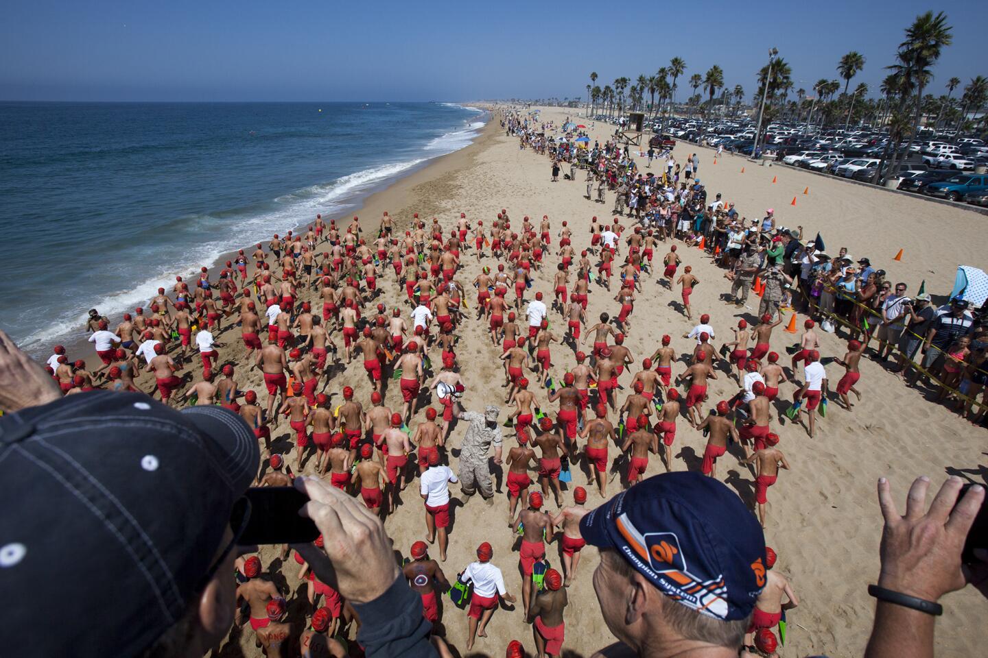 Group C starts their run during the annual monster mile event for the Newport Beach junior lifeguards at the Balboa Pier on Thursday, July 31. (Scott Smeltzer - Daily Pilot)