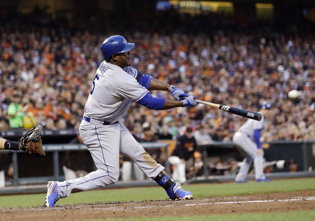 Dodgers third baseman Juan Uribe hits a three-run triple during the third inning of the Dodgers' 10-2 victory over the San Francisco Giants on Friday.