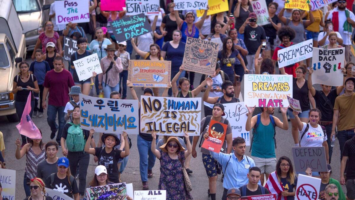 Immigrants and supporters march in Los Angeles on Sunday to oppose President Trump's order to end the Deferred Action for Childhood Arrivals program.