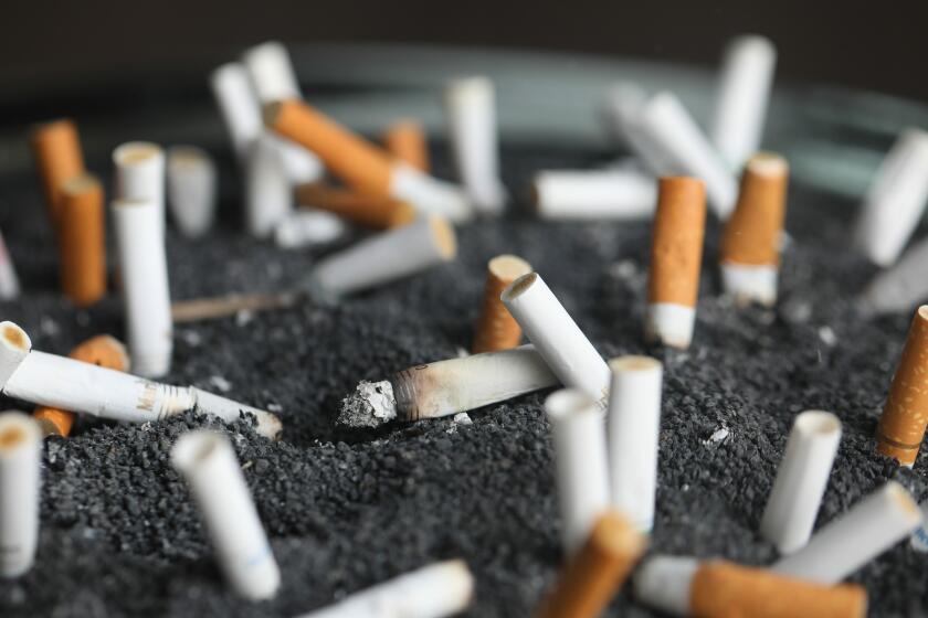 FILE - This March 28, 2019 photo shows cigarette butts in an ashtray in New York. On Tuesday, March 9, 2021. Lung cancer is the nation’s top cancer killer, causing more than 135,000 deaths each year. Smoking is the chief cause and quitting the best protection. (AP Photo/Jenny Kane, File)