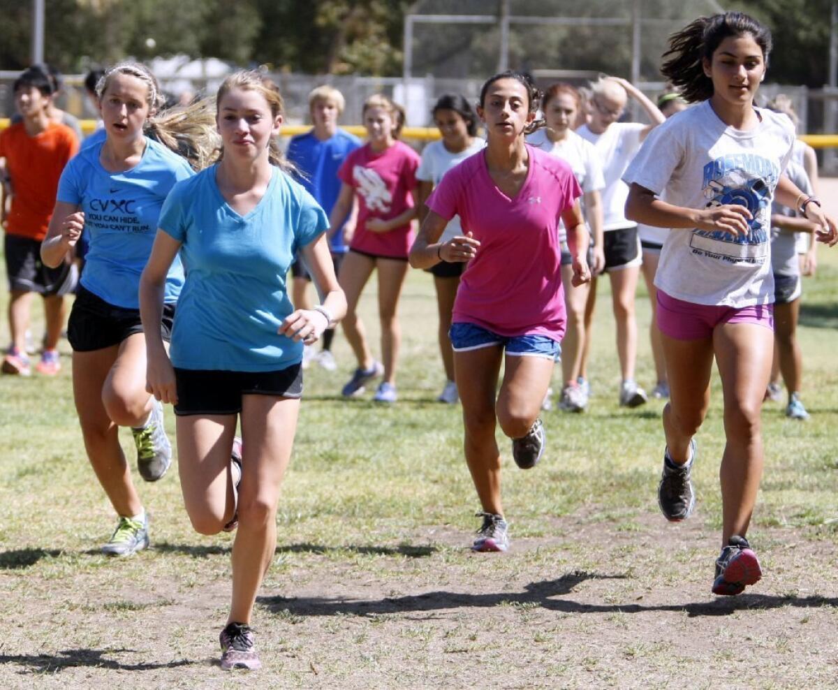 The Crescenta Valley High girls cross-country team, including Haley Witzeman, left, and Rebecca Mencia, second from left, has hopes at a Pacific League and state title in 2013.