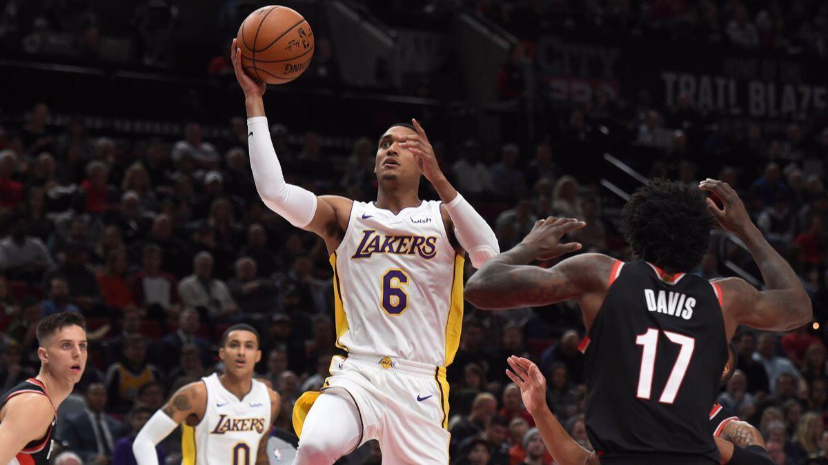 Lakers guard Jordan Clarkson drives to the basket against Portland Trail Blazers forward Ed Davis during the first quarter on Thursday.