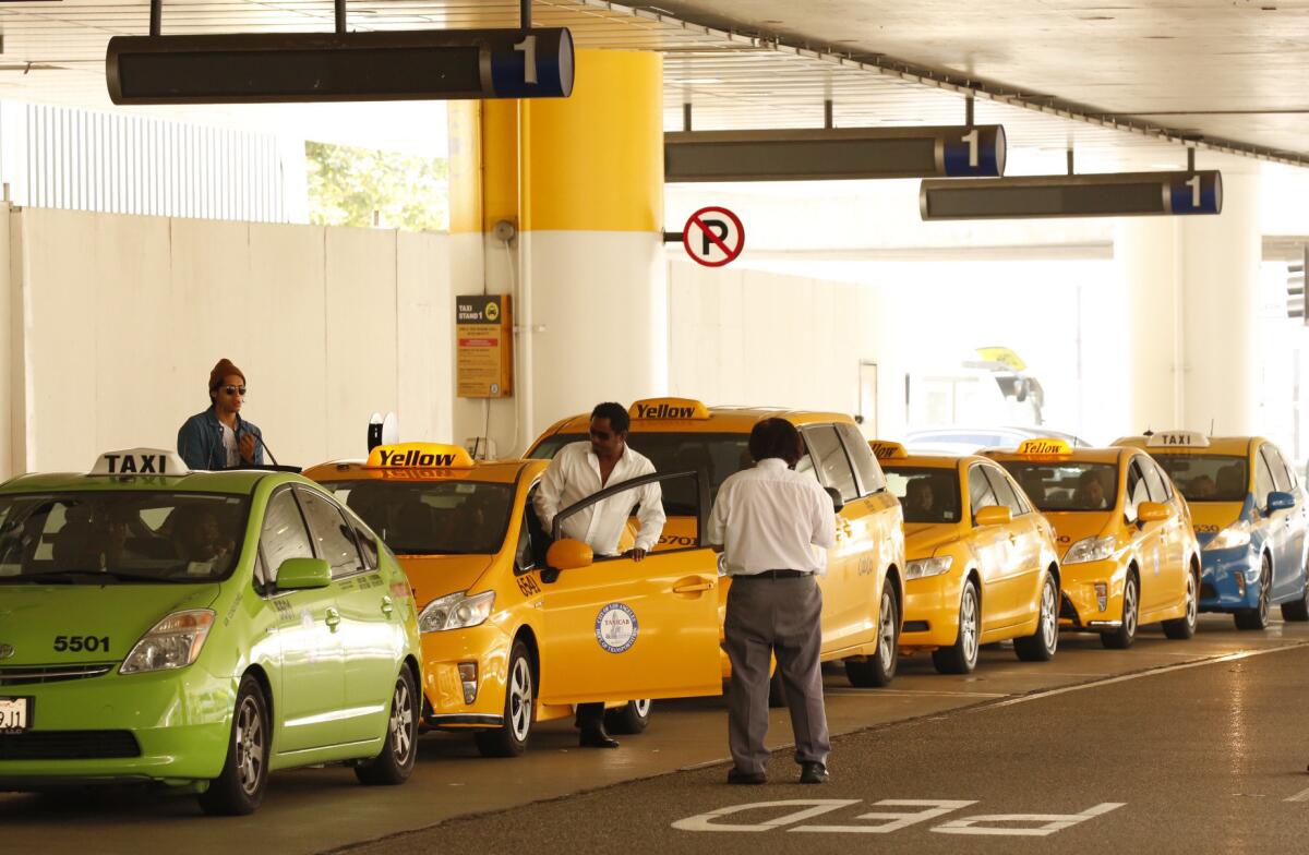 Taxis wait in line at LAX Terminal One on Thursday.