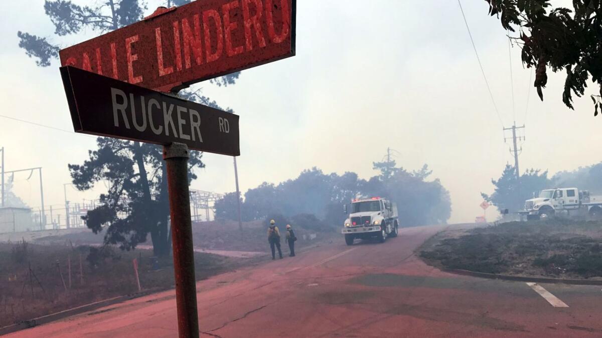 Rucker Road is covered in fire retardant Friday as crews from multiple agencies fight a wildfire in the Mission Hills area of Lompoc, Calif.