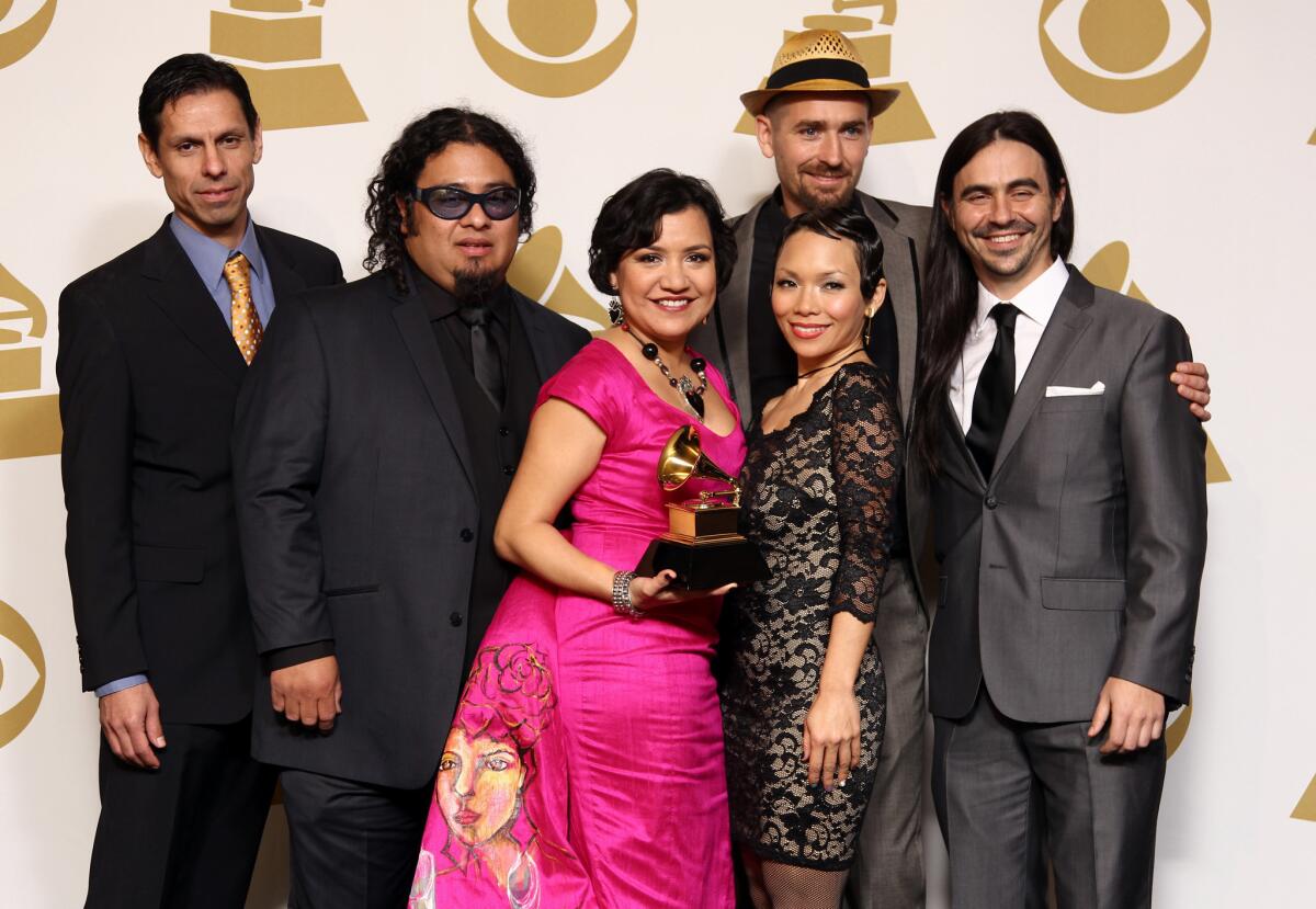 Musical group Quetzal poses backstage with its award for Latin rock, urban or alternative album for "Imaginaries" at the 55th Grammy Awards.