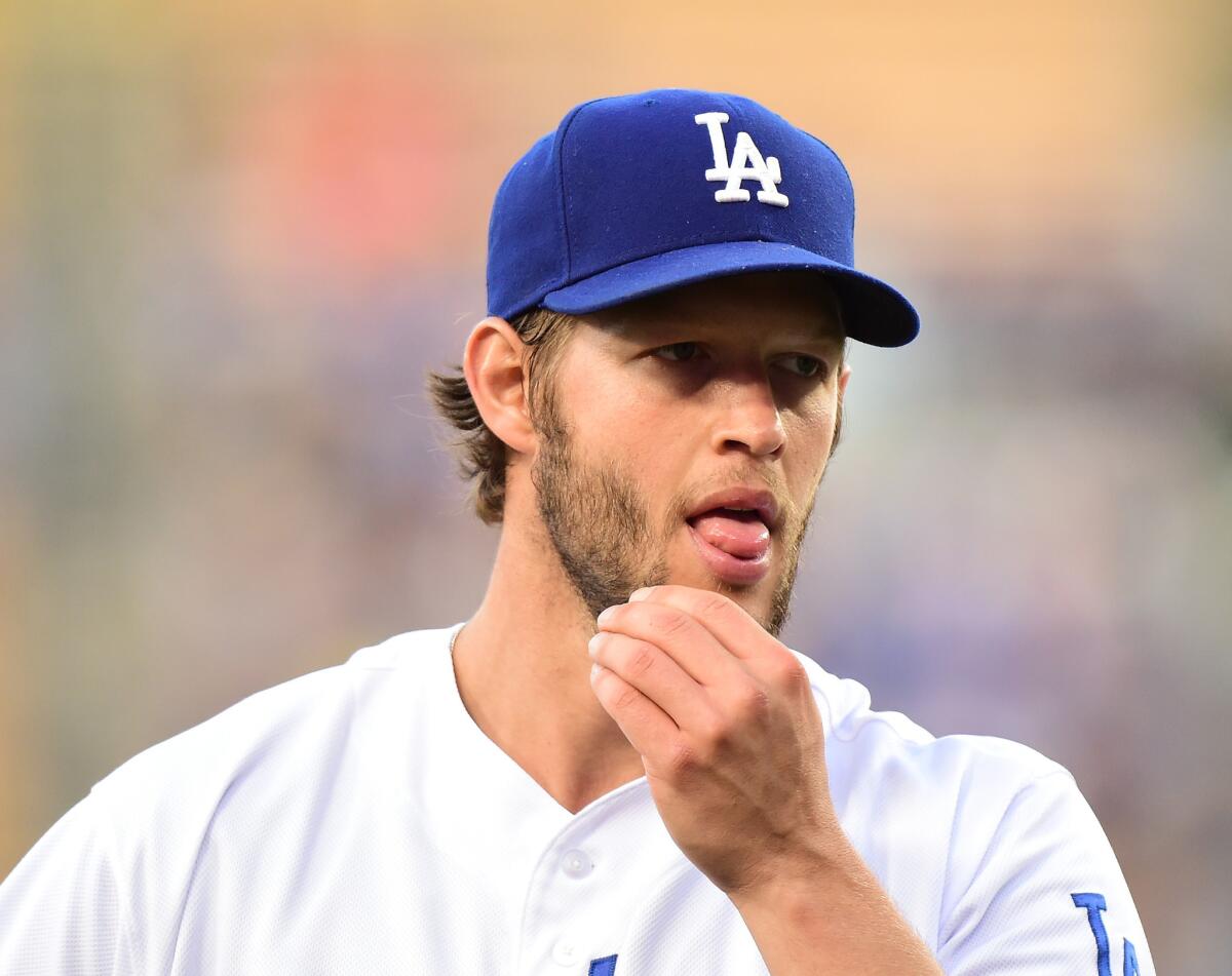 Dodgers starting pitcher Clayton Kershaw reacts as he walks off the mound following the third out against the Reds in the first inning.