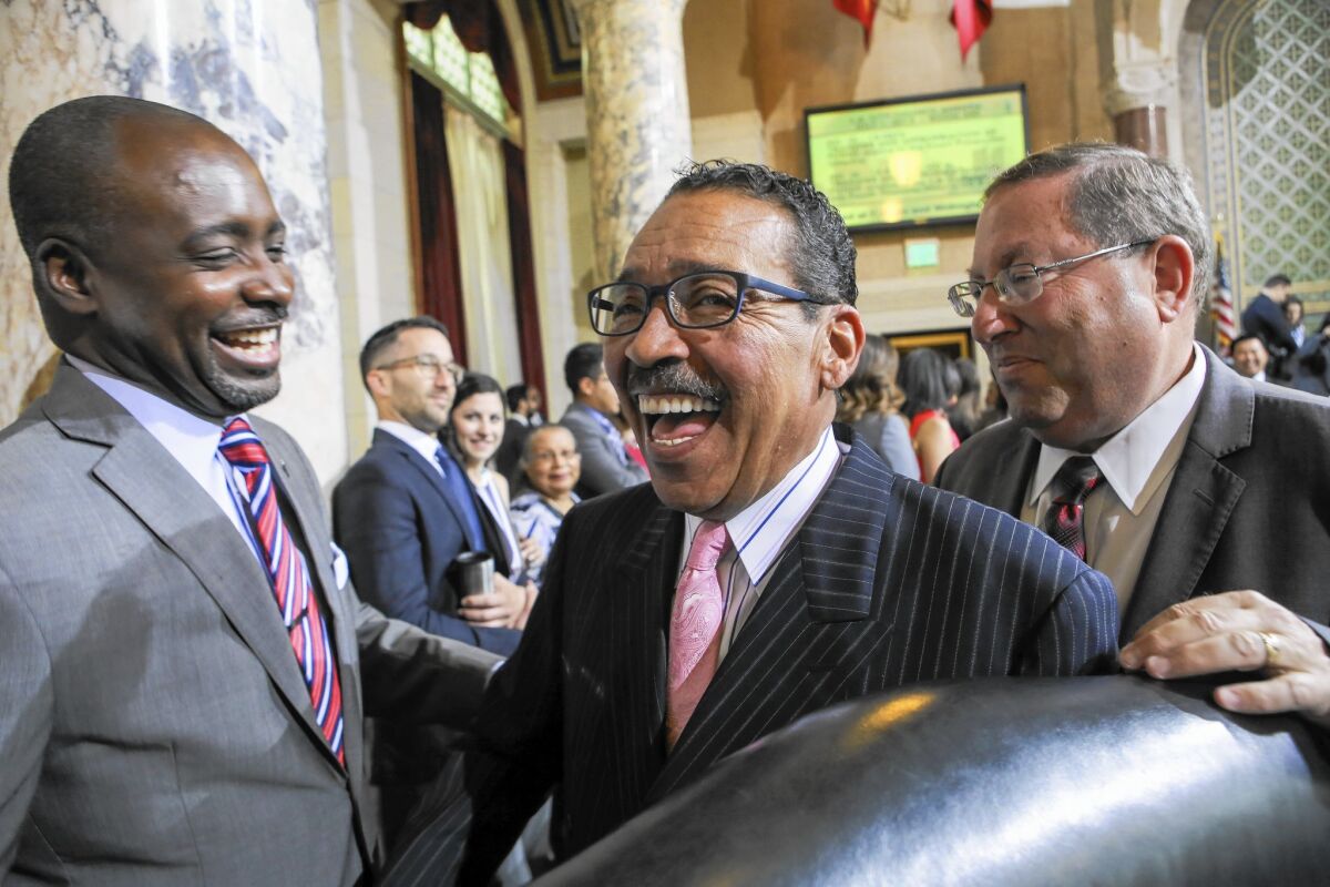 Los Angeles City Council President Herb Wesson, shown in 2015 with council members Marqueece Harris-Dawson, left, and Paul Koretz, said Wednesday he will step down from the post in January.