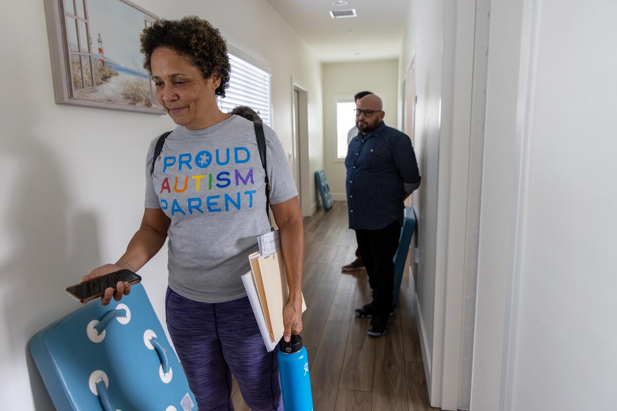 Christine LyBurtus in a hallway of a care facility