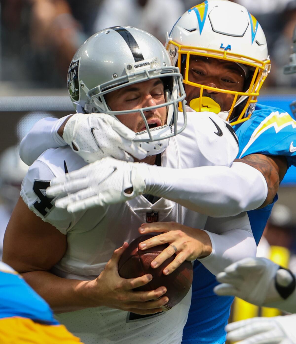  Raiders quarterback Derek Carr (4) is sacked by Chargers safety Derwin James Jr. 