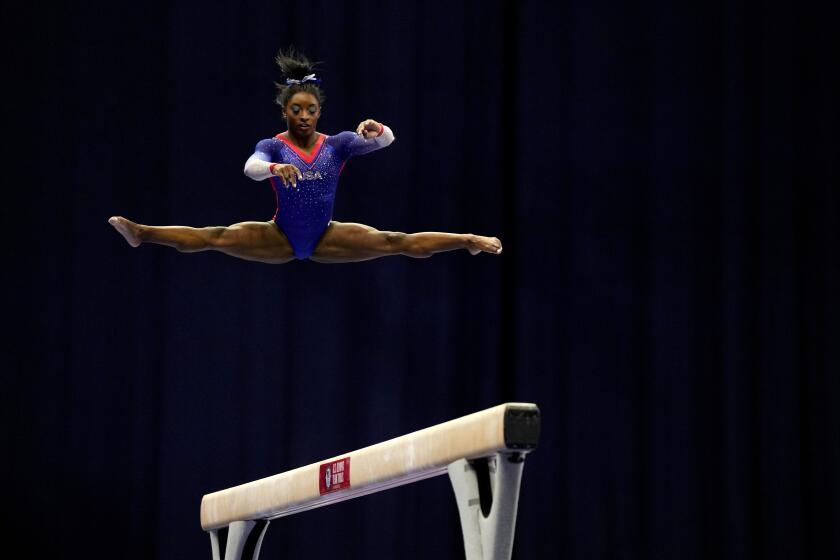 Simone Biles competes on the beam during the women's U.S. Olympic Gymnastics Trials Friday, June 25, 2021, in St. Louis. (AP Photo/Jeff Roberson)