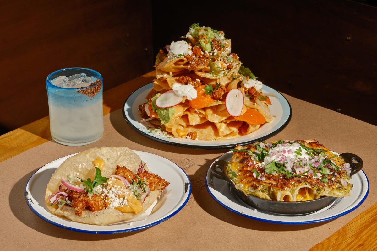 LOS ANGELES , CA - AUGUST 25: The shrimp puffy taco (left), The Super Nachos (center), and mom's green chicken enchiladas (right) from Bar Ama on Friday, Oct. 14, 2022 in Los Angeles , CA. (Shelby Moore / For The Times)