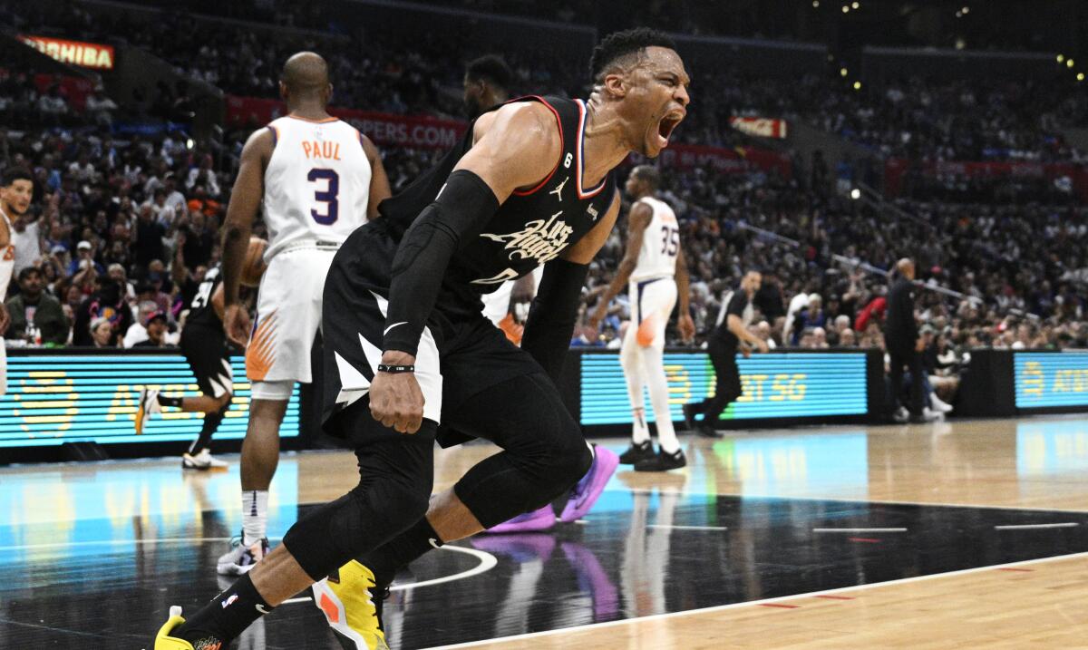 Clippers guard Russell Westbrook flexes as he yells following a breakaway slam dunk against the Phoenix Suns.