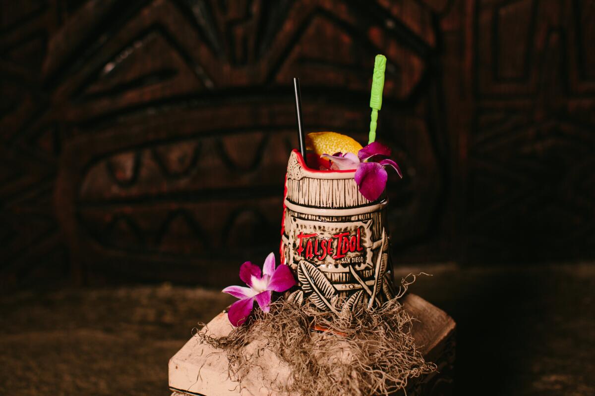 A False Idol signature tiki cocktail in a mug that looks like a barrel