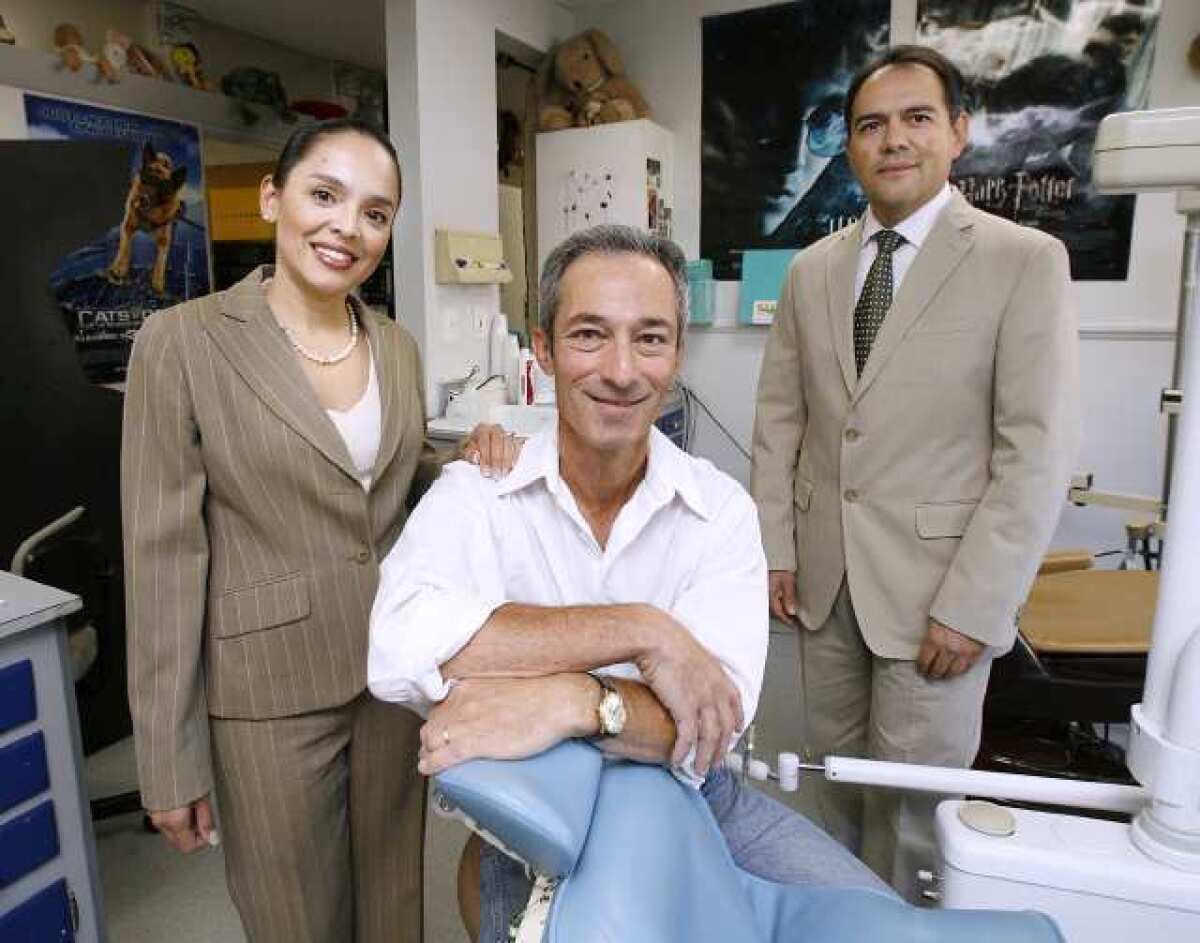 Dr. Marcela Lezama, left, and Dr. Pedro Romero, right, have been working for about four months with Dr. Keith Serxner, center, at Dr. Serxner's dental office in La Canada Flintridge. Dr. Serxner, who's been practicing for 30 years, will retire at the end of the year but Drs. Lezama and Romero will continue to run the children's dental office.