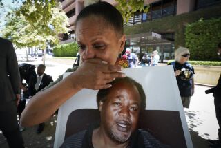 San Diego, CA - August 11: At Federal Courthouse on Thursday, Aug. 11, 2022 in San Diego, CA. Shawn Mills held a photo of her brother, Kevin Mills during a press conference. Kevin Mills died while in San Diego County Jail on November 11, 2020. (Nelvin C. Cepeda / The San Diego Union-Tribune)