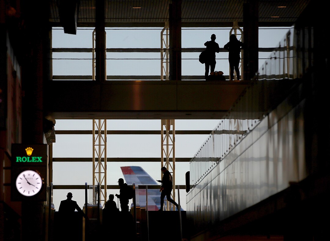  Silhouettes of travelers at Los Angeles International Airport.