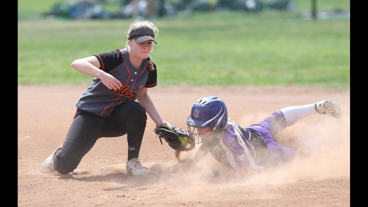 Huntington Beach High shortstop Allee Bunker tags out Pleasanton Amador Valley base stealer during the Michelle Carew Classic in Anaheim on Thursday.