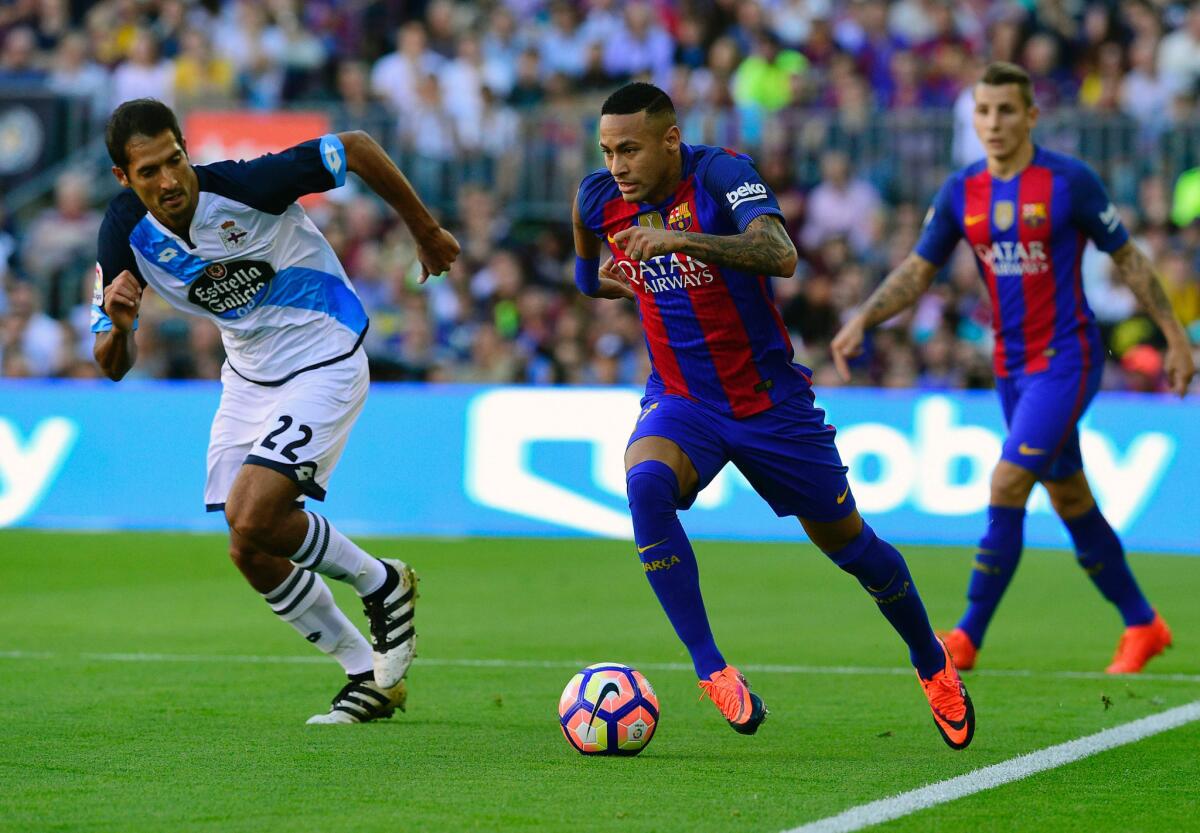 Barcelona forward Neymar dribbles the ball past Deportivo midfielder Celso Borges Mora, left, during a Spanish league match at Camp Nou Stadium in Barcelona on Oct. 15.