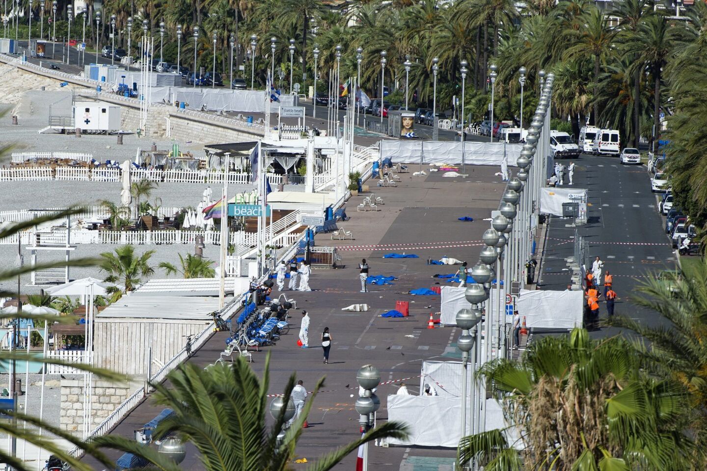 Crime scene investigators work on the Promenade des Anglais after the truck crashed into the crowd during the Bastille Day celebrations in Nice, France.