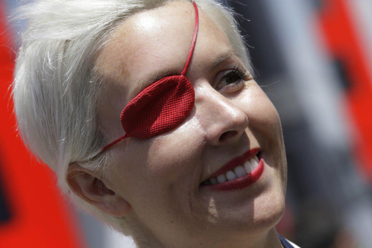 Former Formula One test driver Maria de Villota smiles in the paddock at the Catalunya track in Montmelo, Spain.