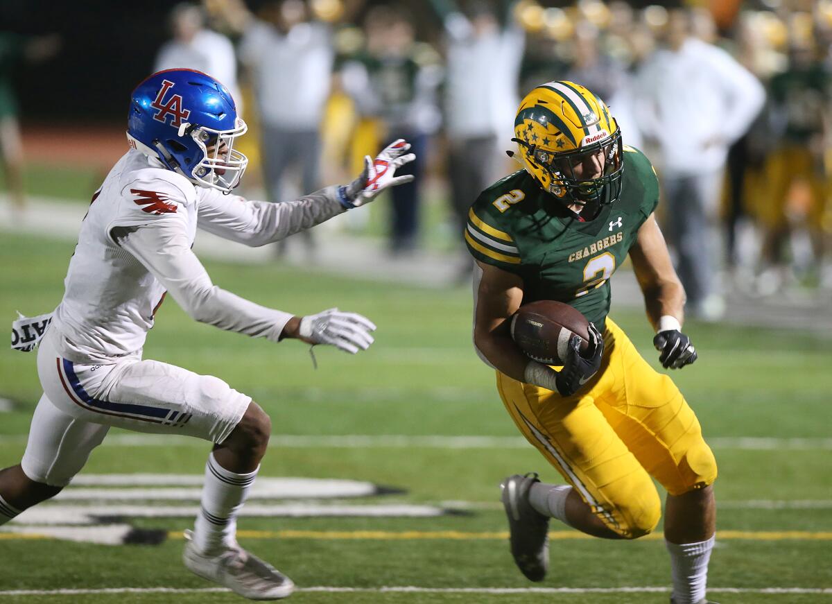 Edison senior Mike Walters, shown running for a touchdown against Los Alamitos on Oct. 4, is a standout two-way player.