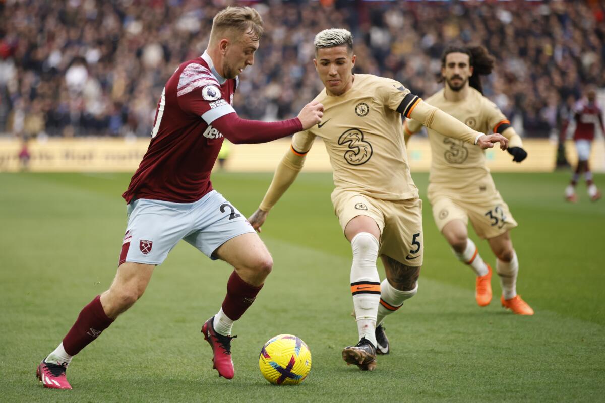 West Ham's Jarrod Bowen, left, challenges Chelsea's Enzo Fernandez for the ball 