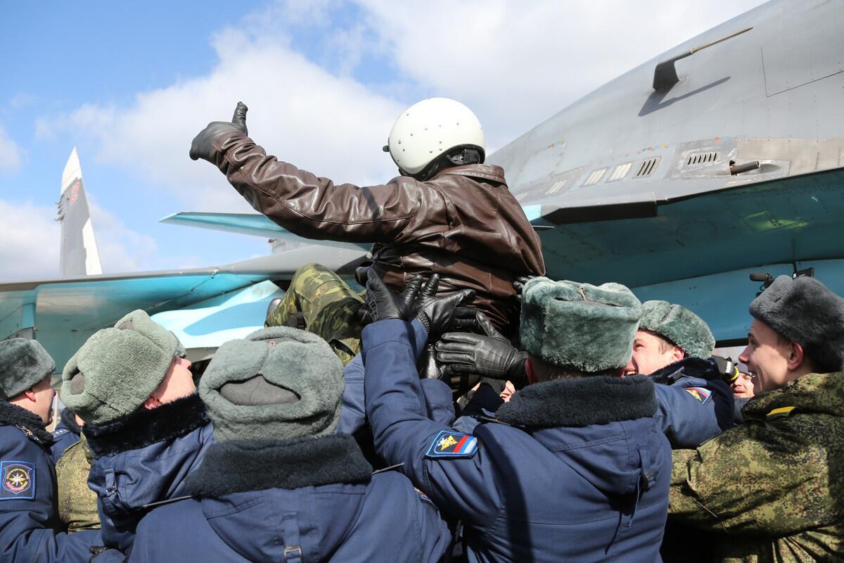 A Russian pilot receives a hero's welcome on returning from Syria at an airbase near the Russian city of Voronezh on Tuesday in a photo provided by the Russian Defense Ministry Press Service.