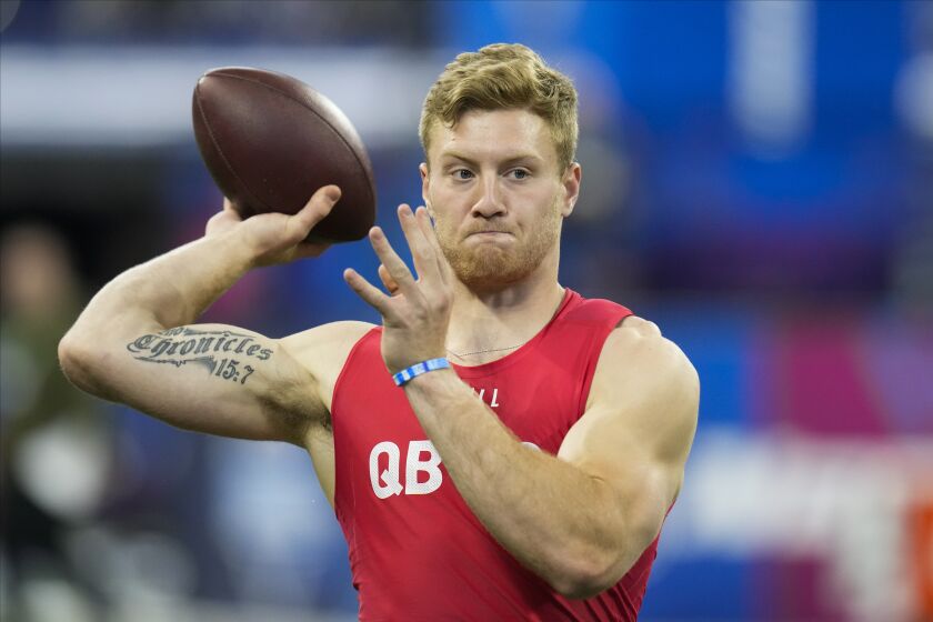 Kentucky quarterback Will Levis warms up before he runs a drill at the NFL football scouting combine in Indianapolis, Saturday, March 4, 2023. (AP Photo/Michael Conroy)