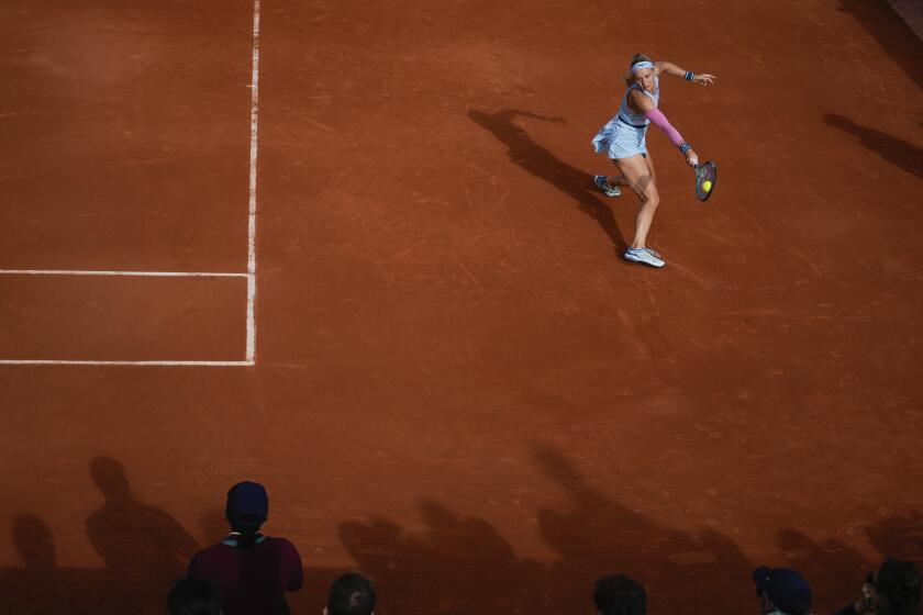 Slovakia's Rebecca Sramkova plays a shot against Amanda Anisimova of the U.S. during their first round match of the French Open tennis tournament at the Roland Garros stadium in Paris, Sunday, May 26, 2024. (AP Photo/Thibault Camus)