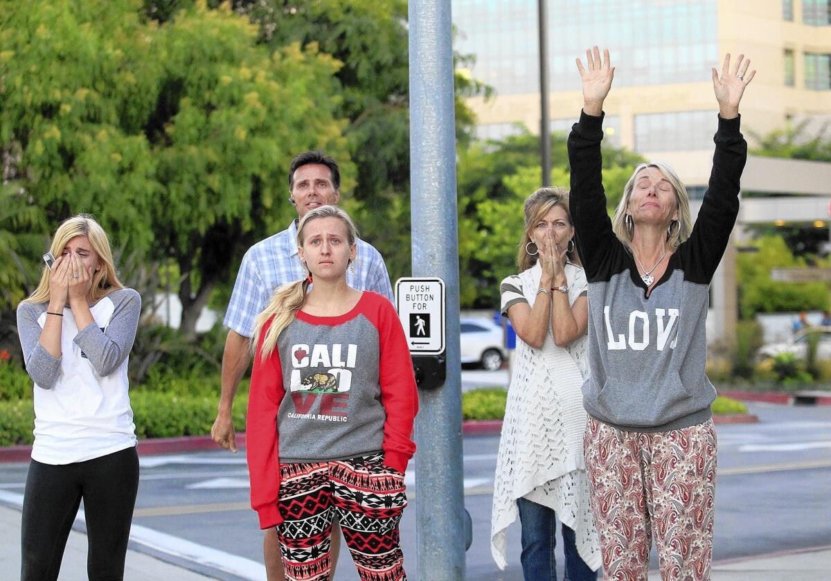 Friends and family of Connor Eckhardt watch as a helicopter with Connor's heart aboard departs from Hoag Hospital.