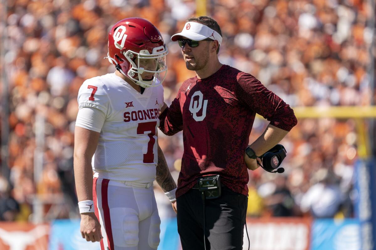 Oklahoma coach Lincoln Riley talks to quarterback Spencer Rattler before a two-point conversion.