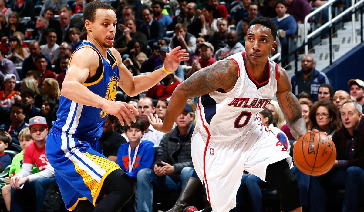 Hawks point guard Jeff Teague (0) drives past Warriors point guard Stephen Curry during their marquee matchup Friday night in Atlanta.