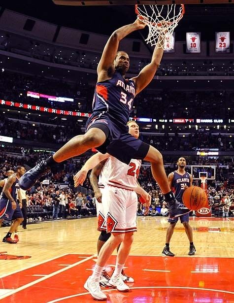 Jason Collins, then of the Atlanta Hawks, finishes a dunk during a game in Chicago.