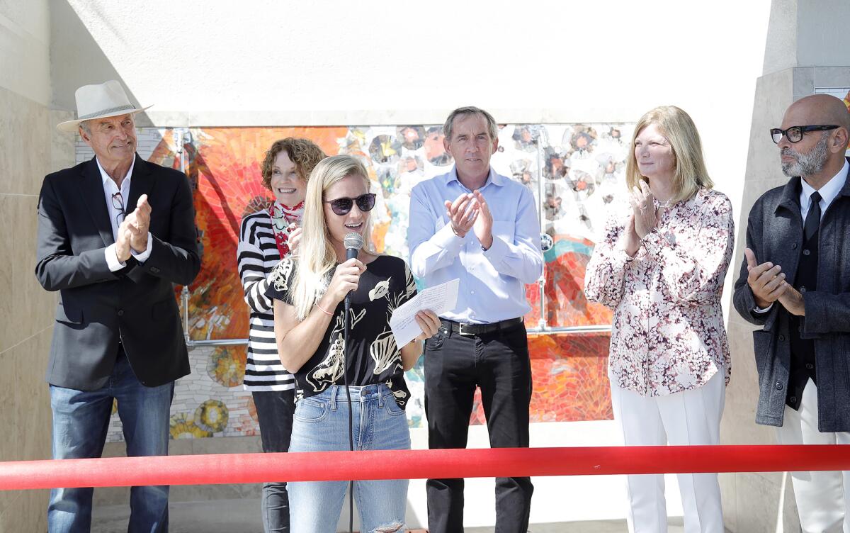 Anne Girtz of the Laguna Bluebelt Coalition makes comments during a ribbon-cutting ceremony at Main Beach on Tuesday.