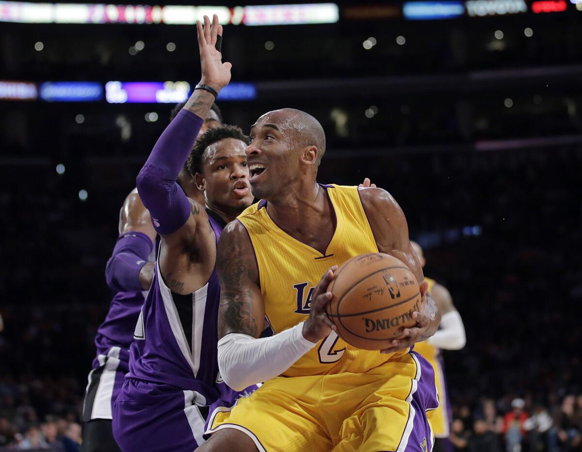 Kobe Bryant looks to shoot as Sacramento guard Ben McLemore defends during the Lakers' 98-95 win over the Kings at Staples Center on Dec 9.