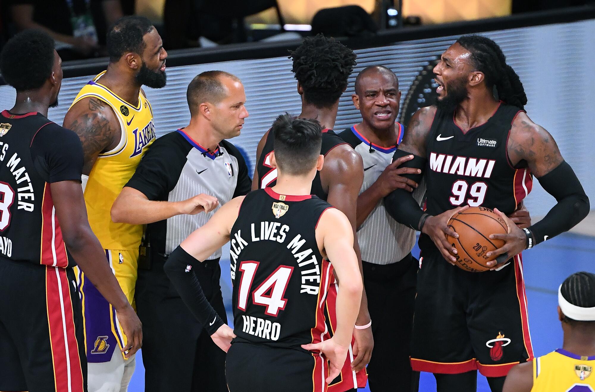 Referees try to separate players after Lakers forward LeBron James was fouled by Heat forward Jae Crowder.