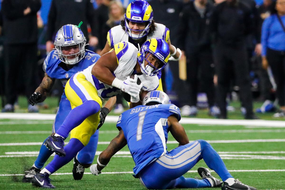 Detroit Lions cornerback Cameron Sutton tries to tackle Rams running back Kyren Williams during the second half.