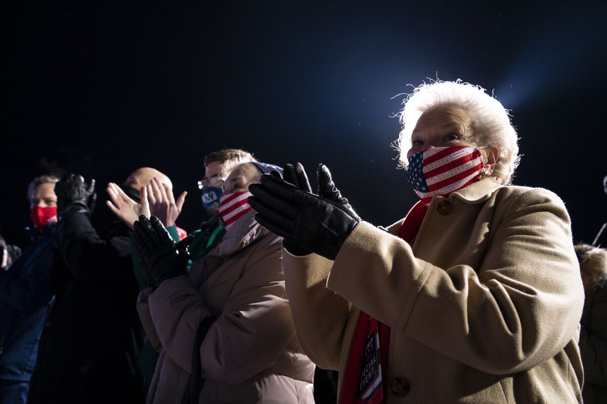 Supporters of President Trump listen during his campaign rally at Eppley Airfield in Omaha on Tuesday.