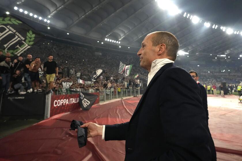 Juventus' head coach Massimiliano Allegri holds his tie at the end of the Italian Cup final soccer match between Atalanta and Juventus at Rome's Olympic Stadium, Wednesday, May 15, 2024. Juventus beat Atalanta 1-0. (AP Photo/Gregorio Borgia)