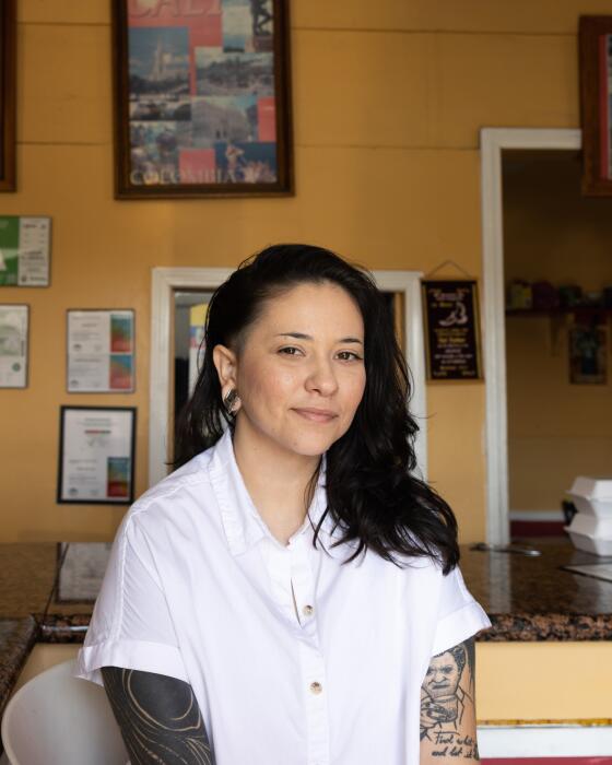 Gisselle Palomera (They/Them), 26, who has Colombian heritage, poses for a photo inside El Molinito in Pico Rivera on Wednesday, March 20, 2024. El Molinito is a Colombian restaurant who, as a child, Palomera and their mother frequented together.