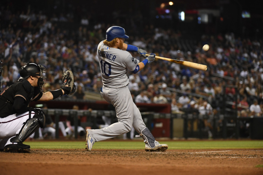 The Dodgers' Justin Turner hits a two-run homer during the seventh inning July 31, 2021, in Phoenix.