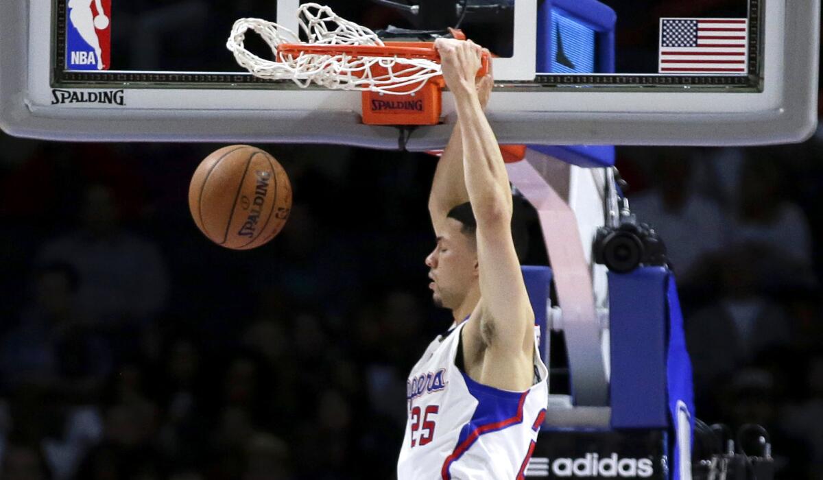 Clippers guard Austin Rivers throws down one of his four dunks against the Sacramento Kings on Saturday night.