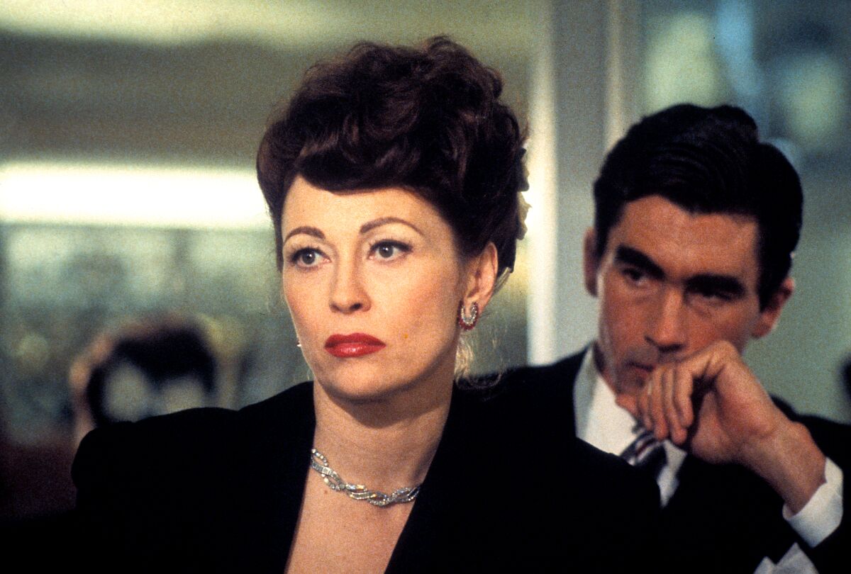 Faye Dunaway, portraying an elegantly dressed Joan Crawford, scowls