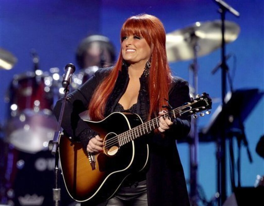 FILE - This April 4, 2011 file photo shows country winger Wynonna Judd from The Judds, performing at the Girls' Night Out: Superstar Women of Country in Las Vegas. Judd says she is postponing scheduled concerts in Canada next week after her husband was hurt in a motorcycling accident in South Dakota, Saturday, Aug. 19, 2012. (AP Photo/Julie Jacobson, file)