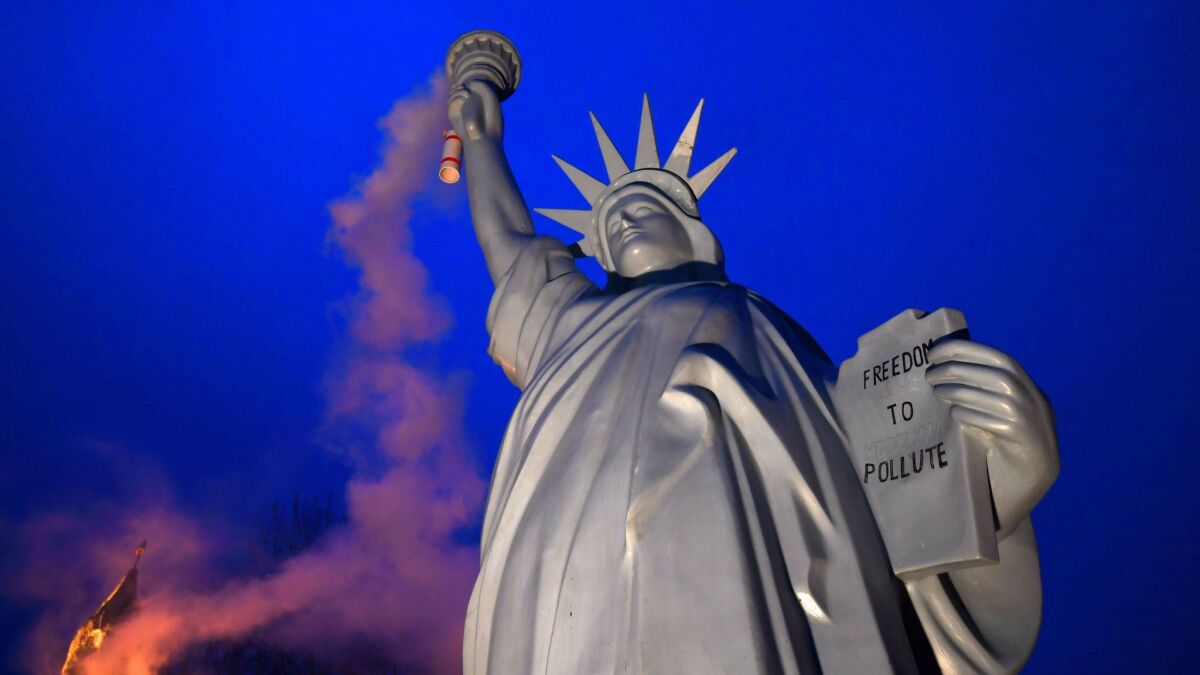 A replica of the Statue of Liberty in Bonn, Germany, mocks Trump administration policies on climate change.