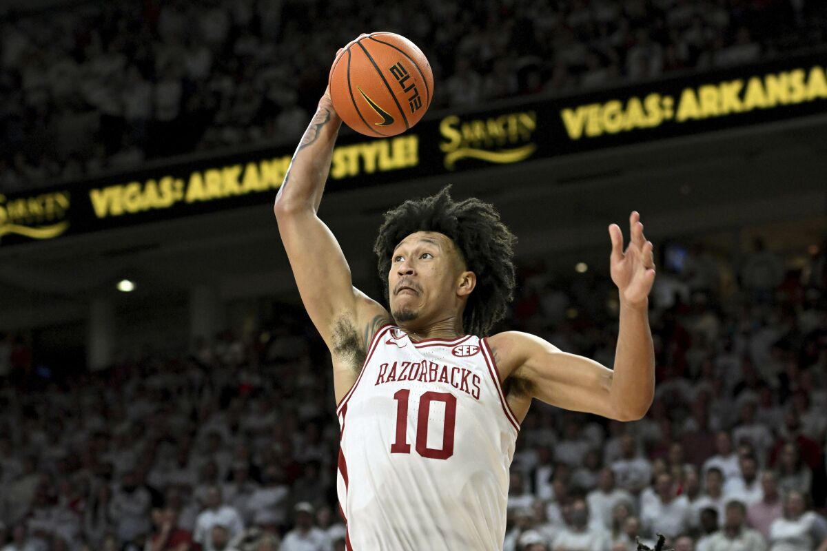 Arkansas forward Jaylin Williams (10) goes up for the dunk against Auburn during the first half of an NCAA college basketball game Tuesday, Feb. 8, 2022, in Fayetteville, Ark. (AP Photo/Michael Woods)