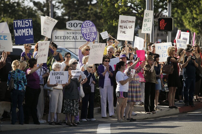 People gather to protest and support Hoag Hospital's decision to stop offering elective abortions.